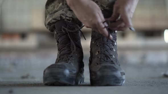 Female Hands Lacing Up Her Old Shoes Getting Ready for Training alt