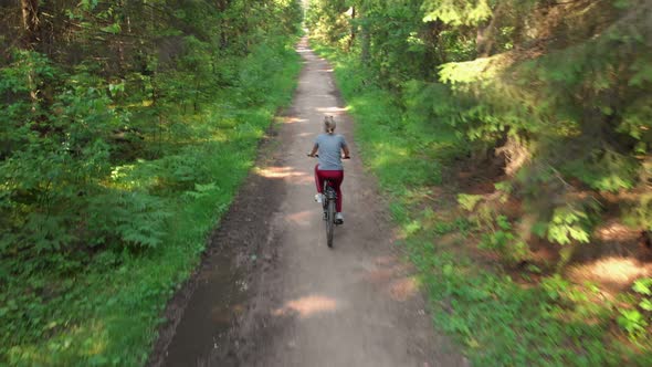 Young Cyclist Riding on a Nice Road alt