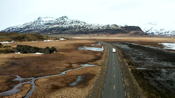 Beautiful Road on a Volcanic Landscape in Iceland. Drone Flying Behind the Car