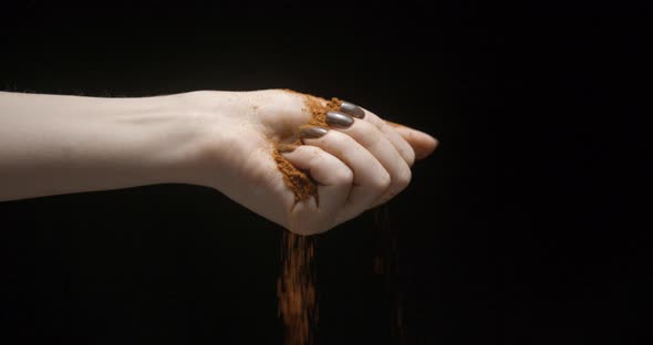 Woman hand with paprika spices falling slow motion