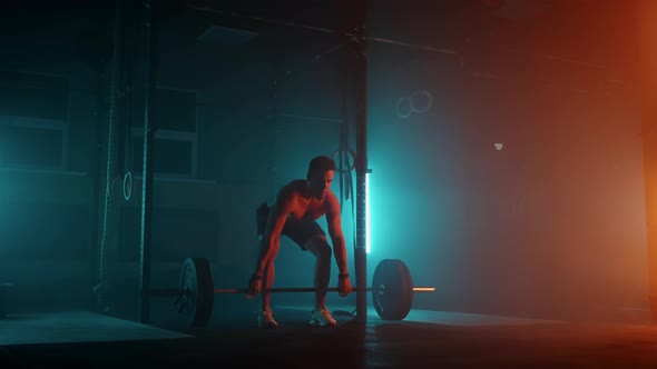 Muscular Fitness Man Doing Push a Barbell Over His Head in Modern Fitness Center alt