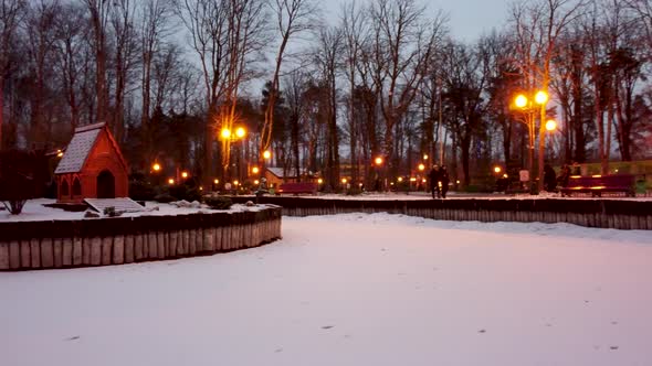 Wintery lake in snowy Kharkiv park. Fly around