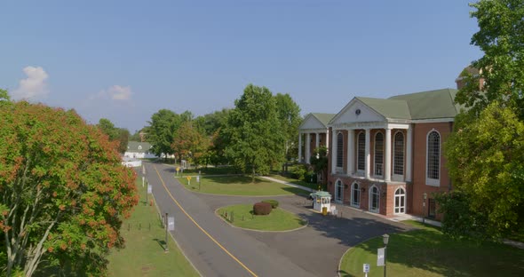 Aerial Pan Towards a Colonial Revival Architecture Style Building in Long Island alt