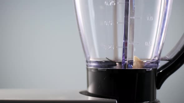 Banana Chunks are Thrown Into Blender to Make Smoothie alt