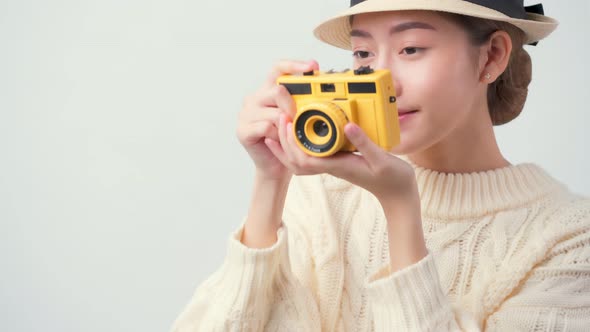 attractive beautiful asian female casual dress wear hat hand hold film camera travel vacation alt