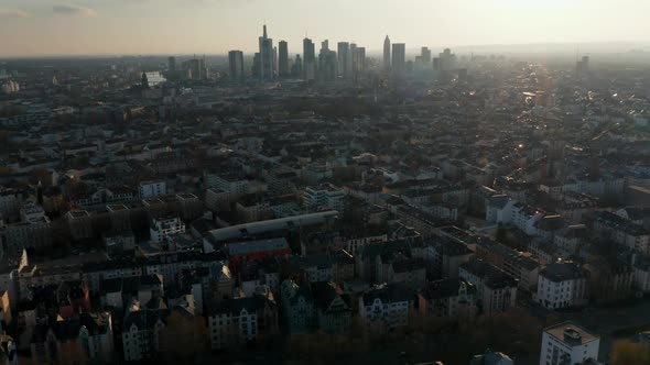 Backwards Flying Drone Above Large City alt