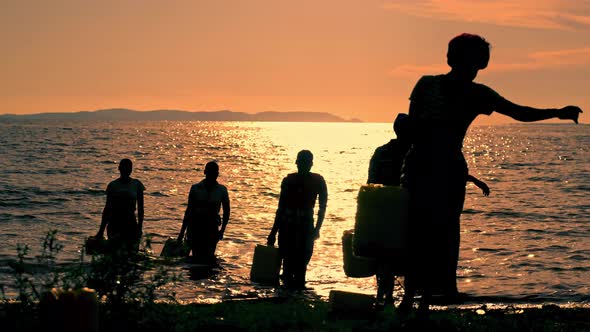 African Women in the Lake at Sunset alt