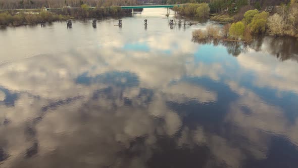 Fabulous Blue Sky with Clouds Reflected in the River Spring Flood alt