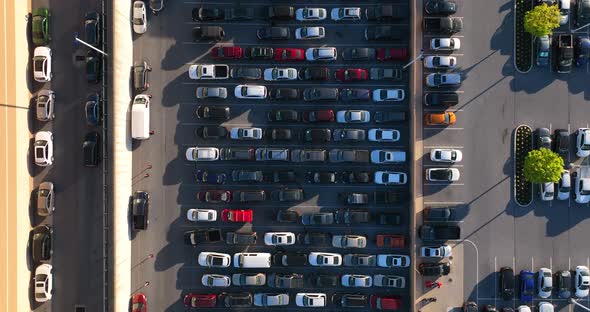 Top down aerial view of full parking lot. Cars parked in CarMax parking lot waiting to be sold. alt