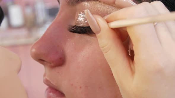 Woman Professional Makeup Artist Doing Makeup of Young Girl Model in Beauty Studio alt