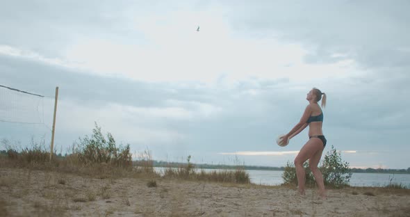 Young Volleyball Player Woman Is Training a Serve of Ball at Open Beach Court, Team Sport, One alt