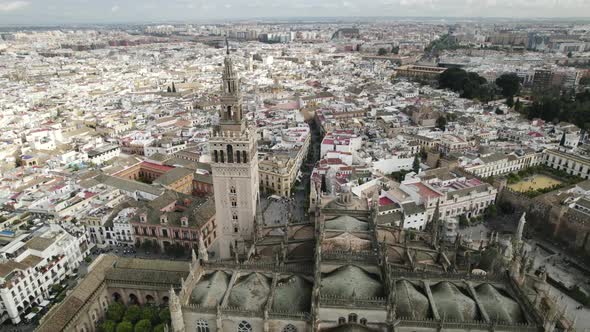 Aerial over iconic UNESCO world heritage site - Seville Cathedral; Spain