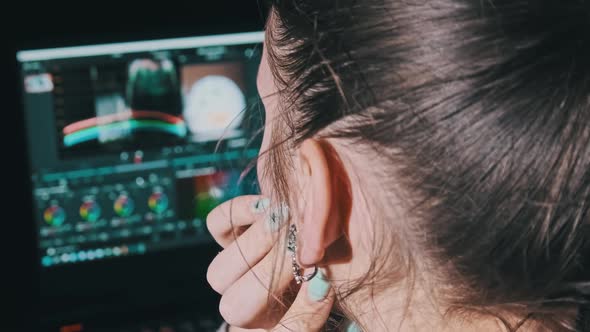 Woman Video Editor Sits at a Laptop and Processes Video Material at Home alt