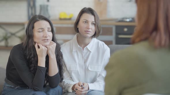 Young Caucasian Women Talking To Unrecognizable Blurred Friend Complaining at Front alt