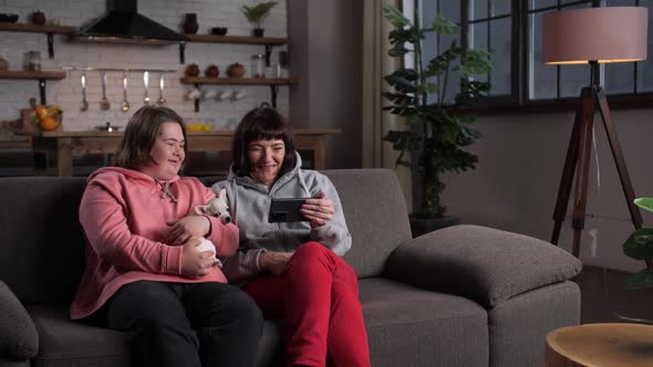 Happy Disabled Child with Mother Relaxing at Home alt