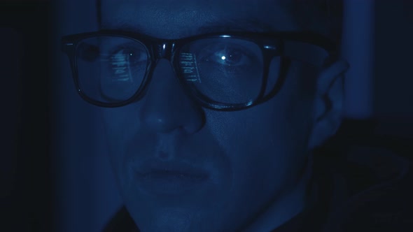 Close Up Face Portrait IT Hacker Programmer Developer in Glasses Working Computer Cyber Attack on alt