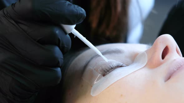 Beautician Separates the Lashes with a Needle and Bends Them Into Curlers. Lash Lamination