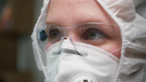 Closeup of Overworked Doctor or Researcher Dressed in Protective Suit Ppe Mask in Laboratory in alt