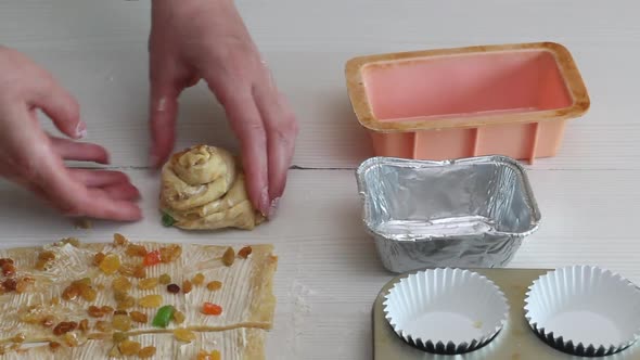 A Woman Prepares A Cruffin With Raisins And Candied Fruits. alt