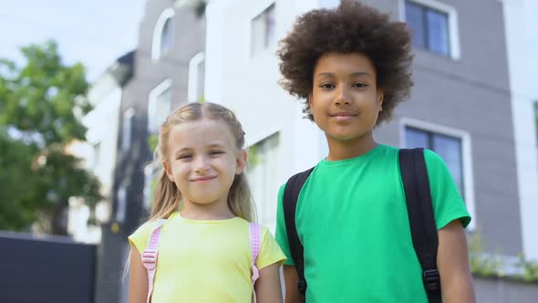 Smiling Afro-American Friend Hugging Little Girl, School Friendship Concept