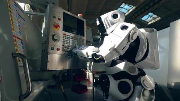 Modern Robot Works with Factory Machine in a Facility alt