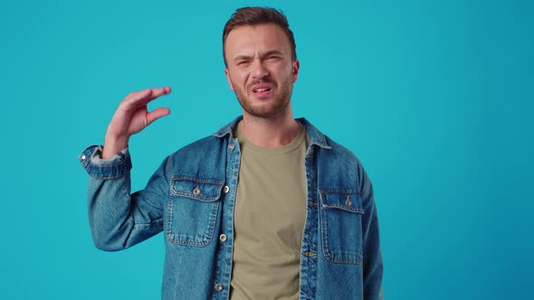 Young Man Showing Blabla Gesture Against Blue Studio Background