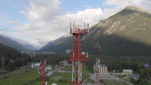 Mobile Telecommunication Tower in the Small Town Between Mountains alt