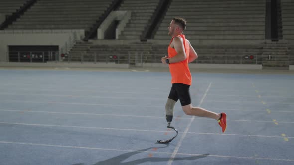 Caucasian disabled male athlete with prosthetic leg training, running alt