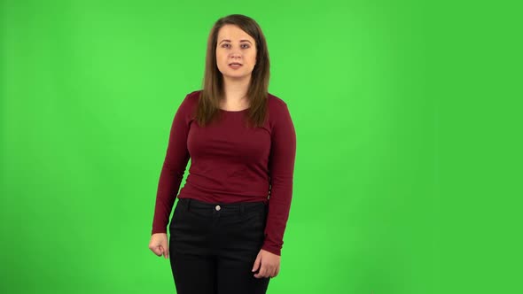 Angry Girl Is Scolding, Shaking Her Index Finger and Threatening with a Fist. Green Screen alt
