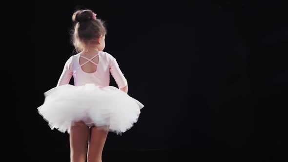 Little Girl Ballerina Caucasian Appearance in a Pink Tutu Dances on Stage alt
