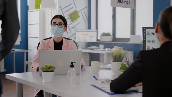 Business People with Medical Face Masks Working Together in New Normal Office alt