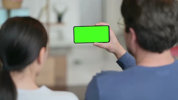 Couple Using Smartphone with Green Chroma Key Screen alt