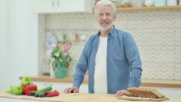 Old Man Shaking Head As Yes Sign While in Kitchen alt