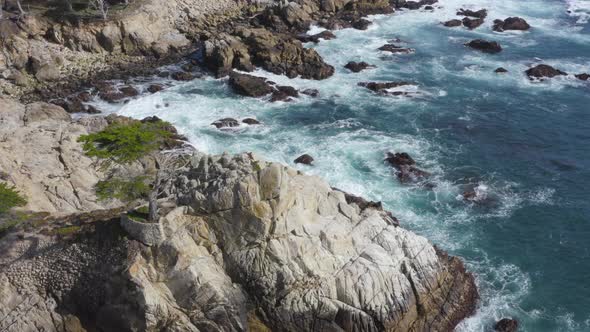Aerial Pan Around of Waves Crashing on the Rocky Shores of Big Sur California alt