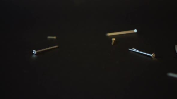 Nails falling on black background Sony a6300 100fps alt