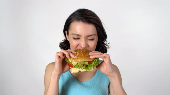 Young Woman Enjoying Burger alt