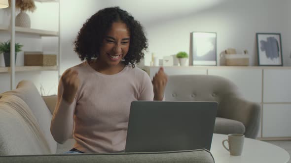 Young Positive African American Woman Freelancer Typing on Laptop Chatting with Clients and Enjoying alt