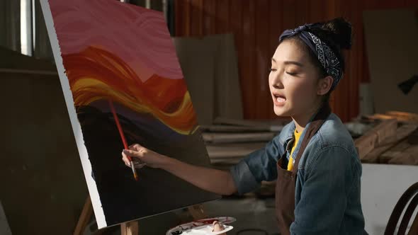 Asian Female Artist Draws create art piece Make an online tutor with palette and brush painting.