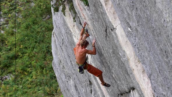 A man rock climbing up a mountain. alt