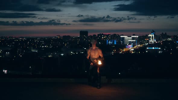 Young Blond Male Does Tricks with Fire, Male Kneels While Breathing Fire Making Fireball alt