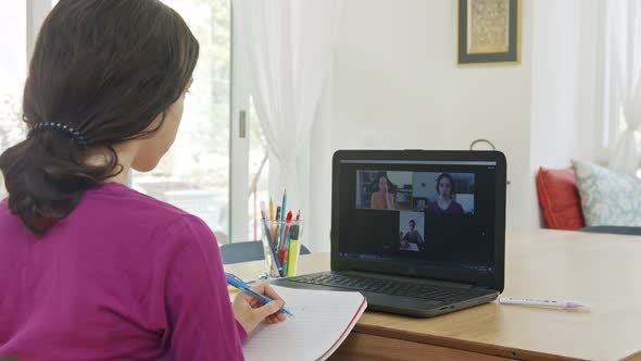 Teenage girl attending an online lesson during the COVID-19 lockdown