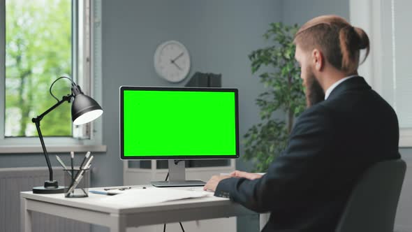 Man Working on Green Screen Pc