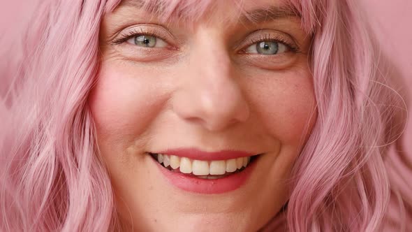 Closeup of Human Female Face with Pink Hair Looking at the Camera
