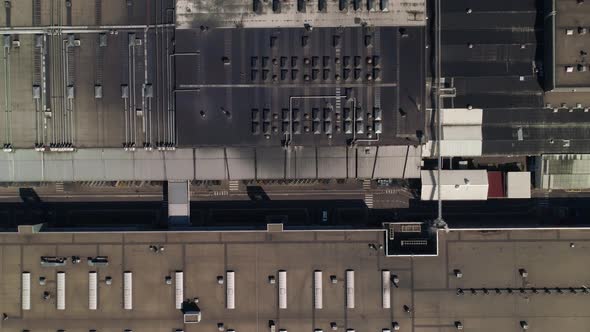 Big factory rooftop. Top down, orthophoto. Aerial drone shot camera ascending.