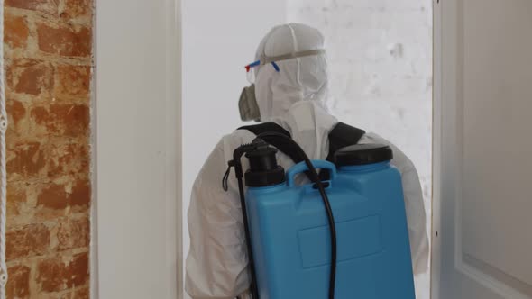 Man in Hazmat Making Disinfection in Flat, Coronavirus Disinfection alt