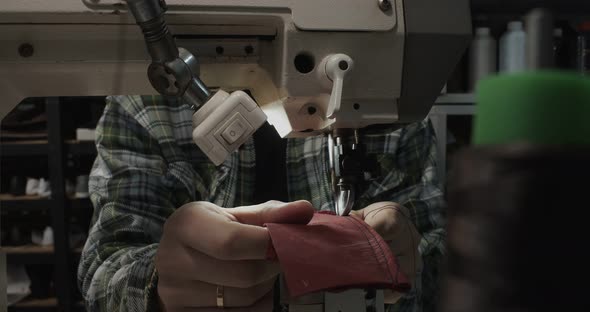 Tailor Works on Sewing Machine in Private Leather Craftshop Making Shoes in Process