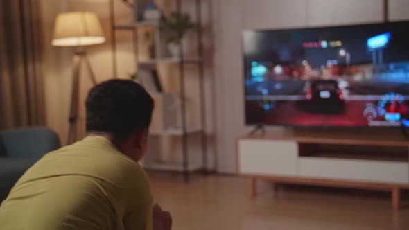 Kid Gamer Playing Car Race Game On Tv At Home alt