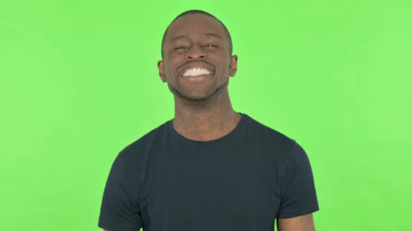 Young African Man Shaking Head As Yes Sign on Green Background alt