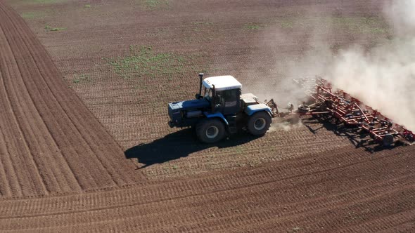 Aerial View to Tractor Plowing Field alt