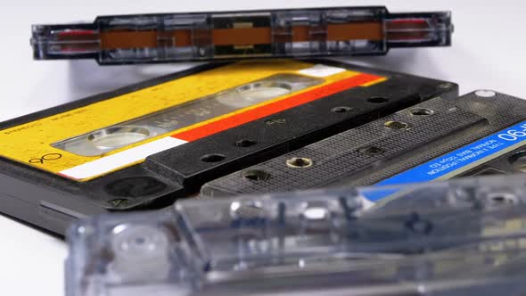 Four Audio Cassettes Rotate on White Background alt
